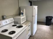 View of kitchen including stove and refrigerator.